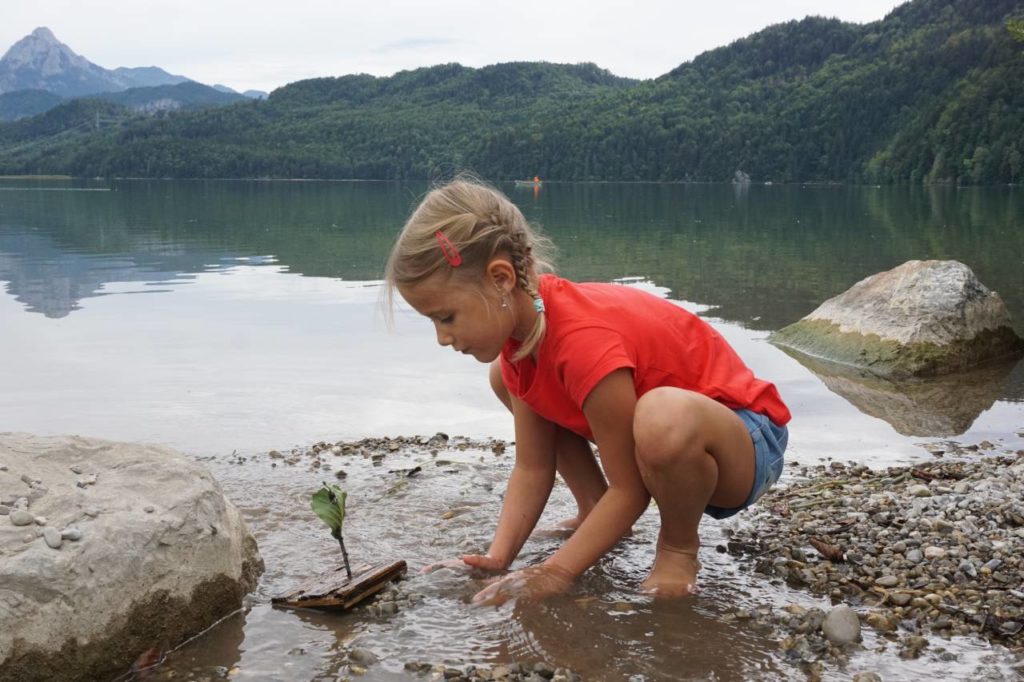 Kind spielt am Weissensee bei Füssen