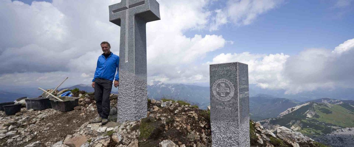 Raimund Walser mit steinernen Gipfelkreuz